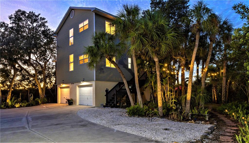 7325 Holly Road Terra Ceia, FL 34250 - Photo 59 of 87 a front view of a house with a yard and tree s