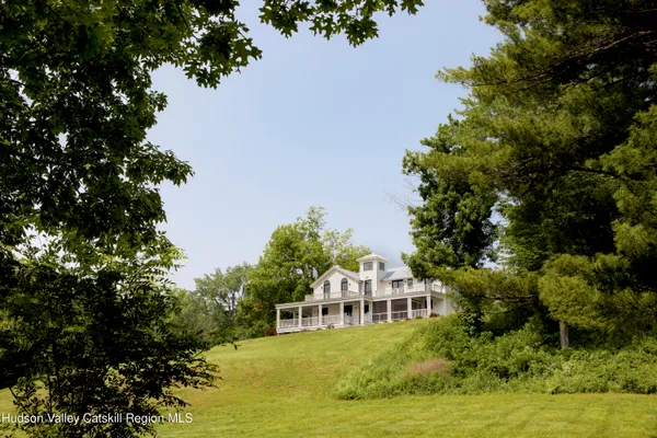 a front view of a house with a yard table and chairs