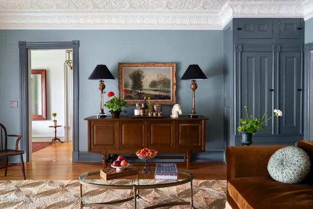 a living room with furniture a window and a chandelier