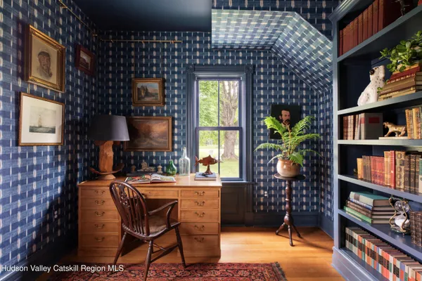 a dining room with furniture potted plants and wooden floor