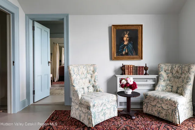 a bedroom with a bed and a chair