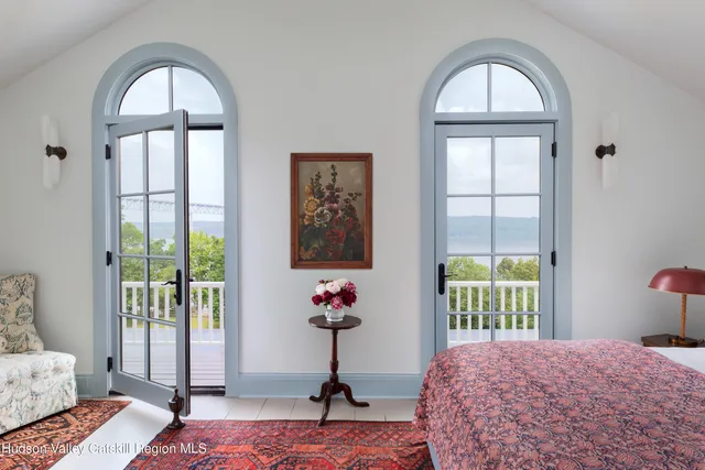 a bedroom with a bed and a mirror