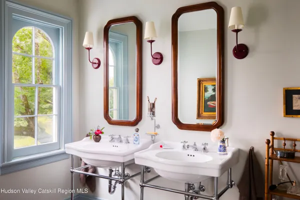 a bathroom with a sink mirror and vanity