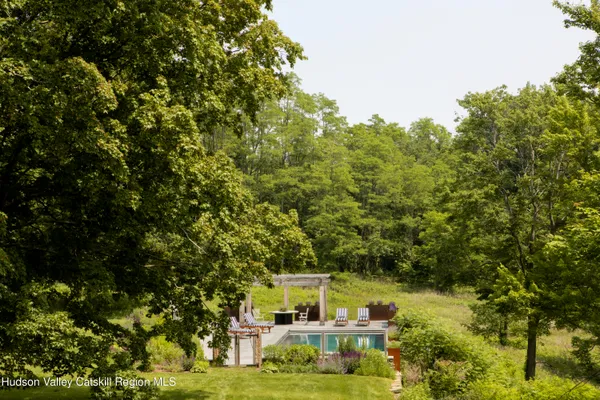 a dining room with furniture a potted plant and a window
