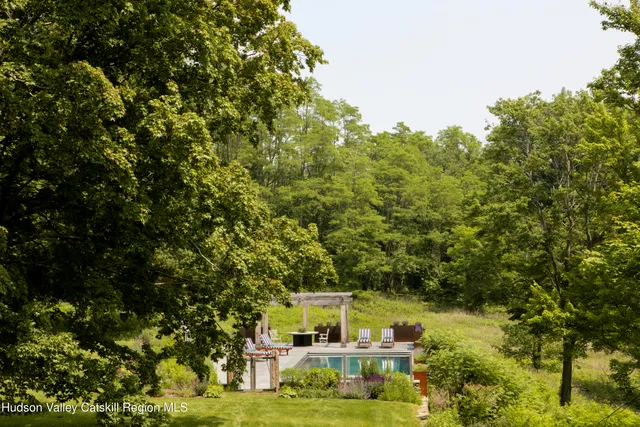 a dining room with furniture a potted plant and a window