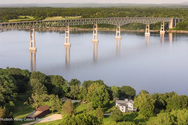 a front view of a house with a garden and plants