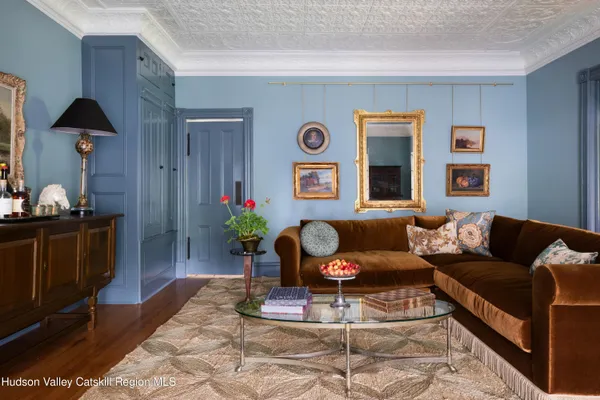a living room with fireplace furniture and a large window