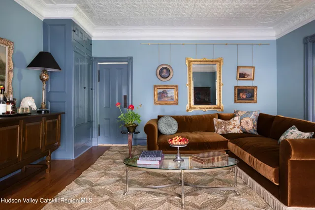 a living room with fireplace furniture and a large window