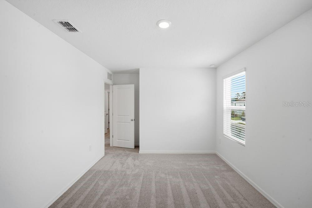 13245 Tropical Breeze Way Hudson, FL 34669 - Photo 12 of 41 a view of an empty room with a window
