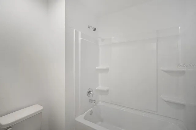 a bathroom with a bathtub and toilet
