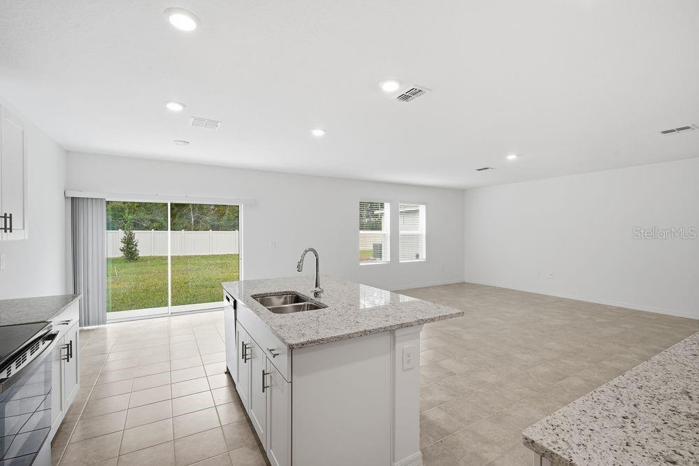 13245 Tropical Breeze Way Hudson, FL 34669 - Photo 2 of 41 a kitchen with sink cabinets and window