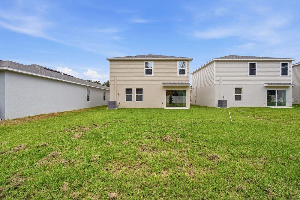 13245 Tropical Breeze Way Hudson, FL 34669 - Photo 27 of 41 a front view of house with yard