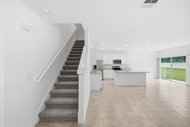 a view of a kitchen with furniture and staircase