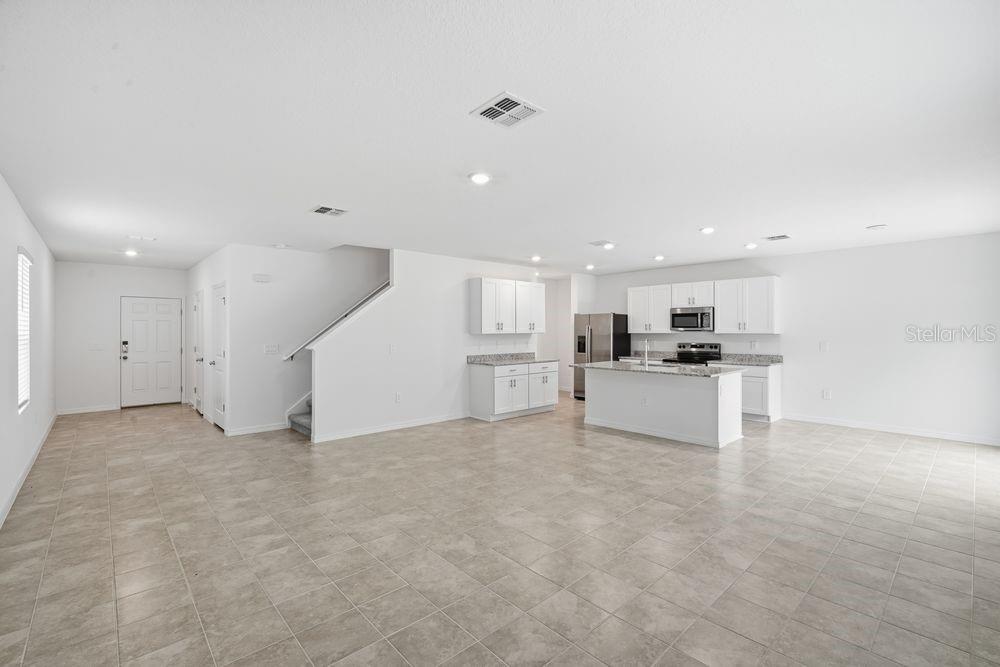 13245 Tropical Breeze Way Hudson, FL 34669 - Photo 4 of 41 a view of kitchen with kitchen island white cabinets and refrigerator