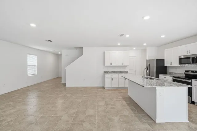 a view of kitchen with center island and stainless steel appliances