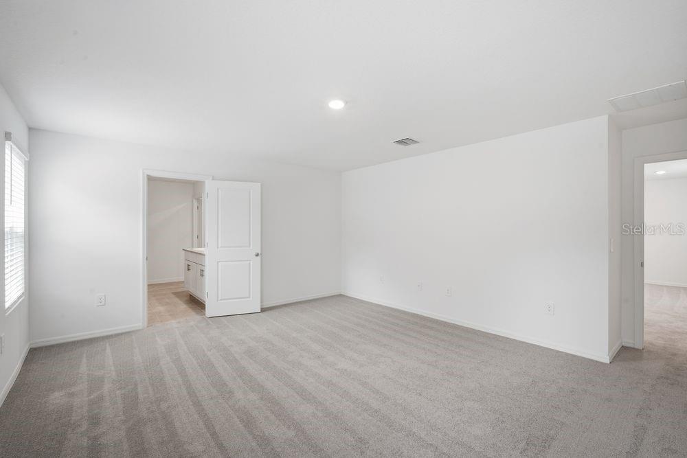 13245 Tropical Breeze Way Hudson, FL 34669 - Photo 9 of 41 a view of an empty room with wooden floor and closet