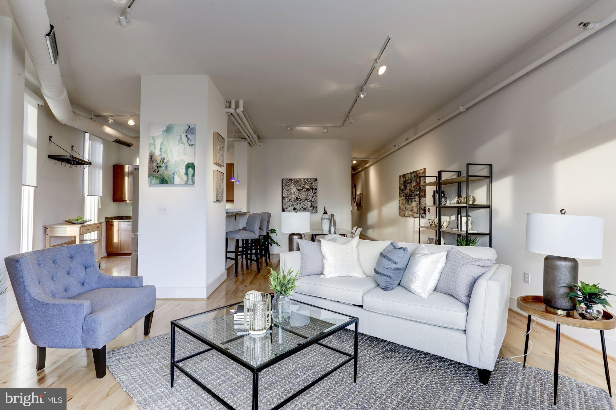 1700 Kalorama Road Northwest, Unit 312 Washington, DC 20009 - Photo 2 of 45 a living room with furniture and a chandelier