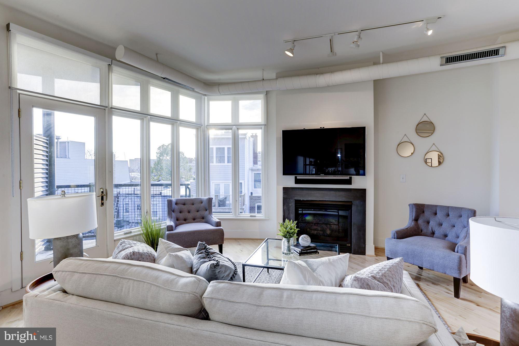1700 Kalorama Road Northwest, Unit 312 Washington, DC 20009 - Photo 9 of 45 a living room with fireplace furniture and a flat screen tv