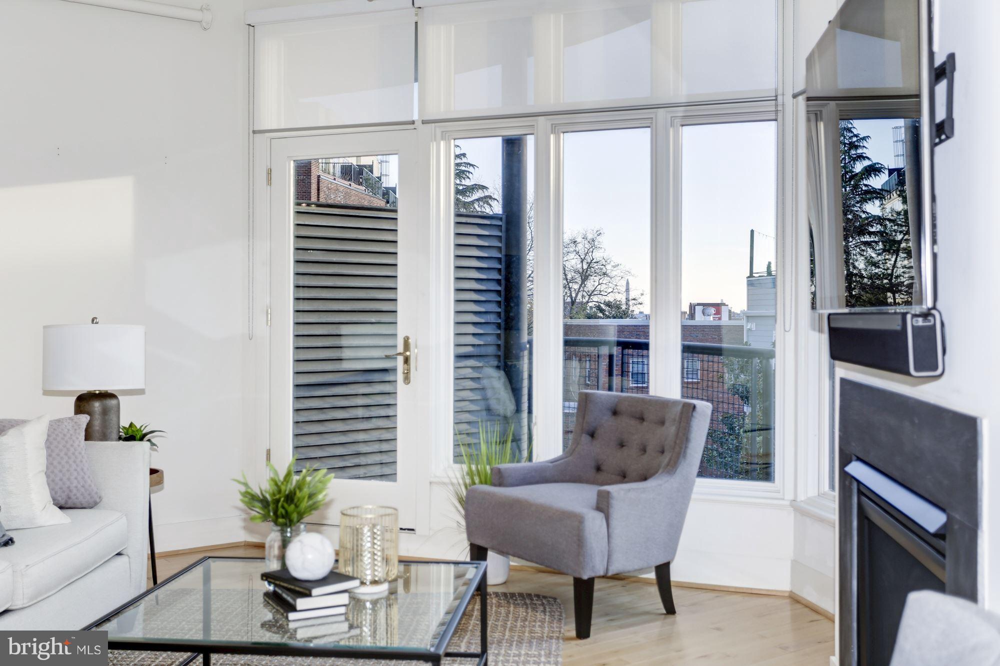 1700 Kalorama Road Northwest, Unit 312 Washington, DC 20009 - Photo 10 of 45 a living room with furniture and a large window