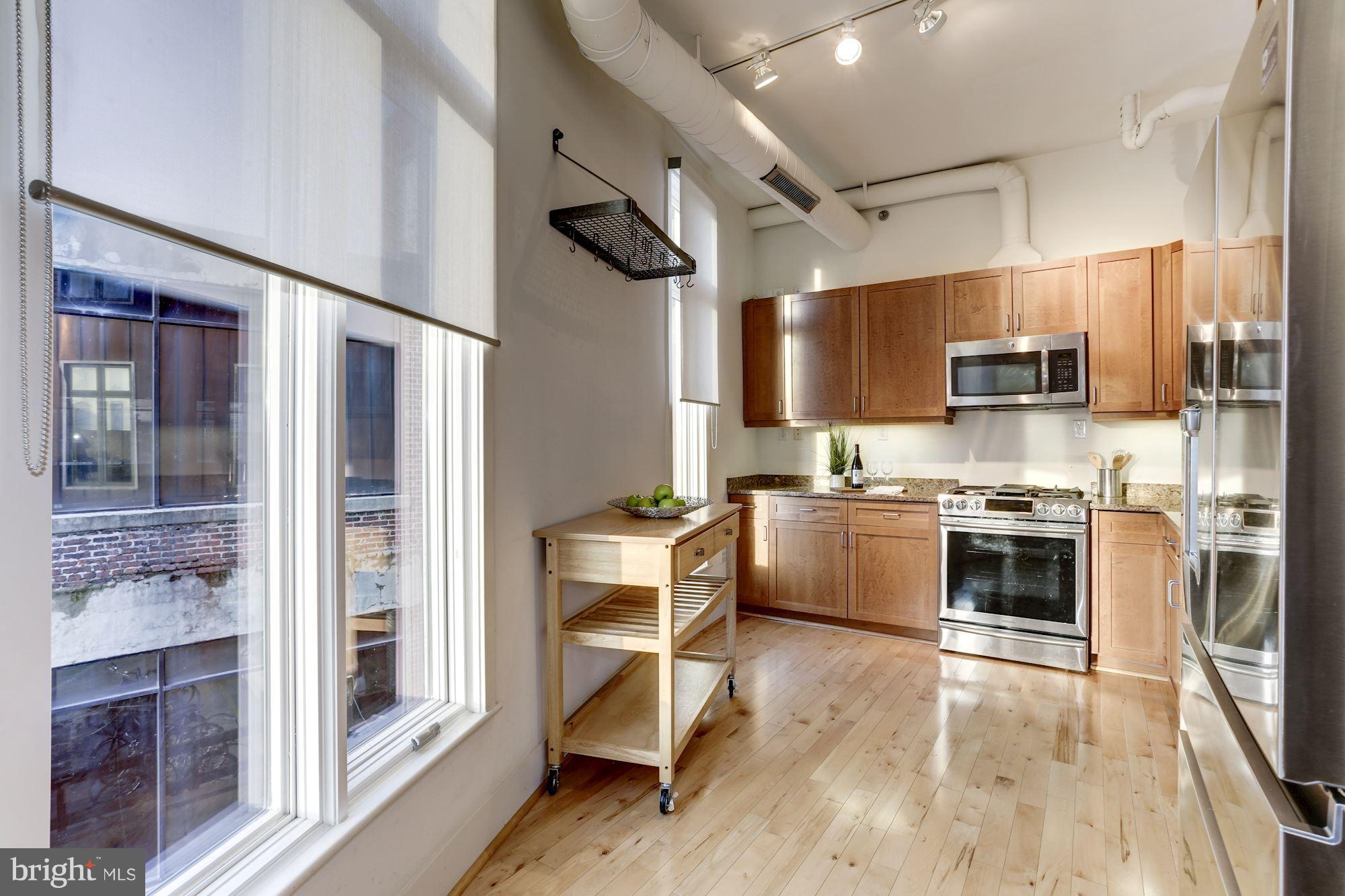 1700 Kalorama Road Northwest, Unit 312 Washington, DC 20009 - Photo 13 of 45 a kitchen with stainless steel appliances a stove a refrigerator and a sink