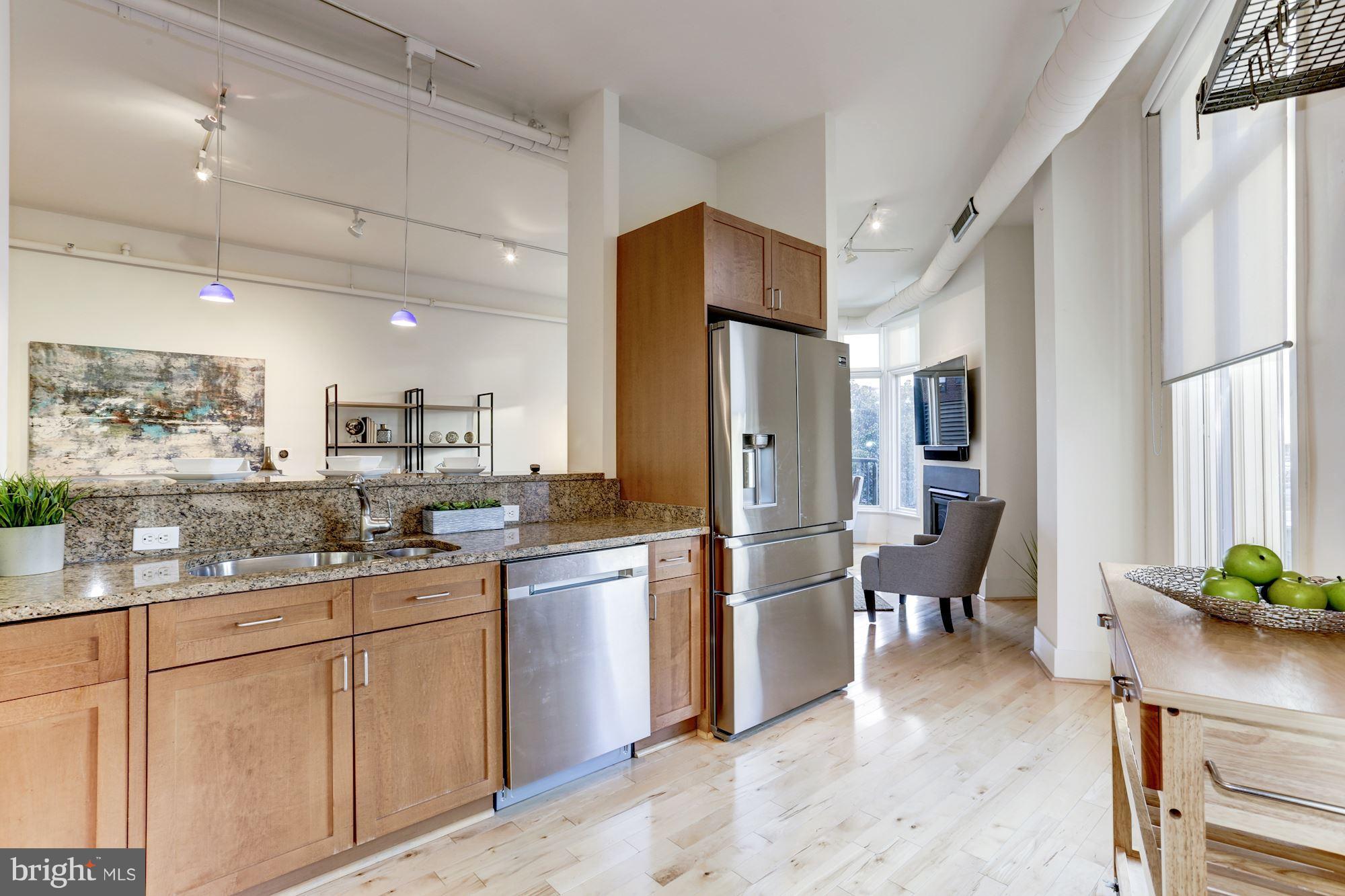 1700 Kalorama Road Northwest, Unit 312 Washington, DC 20009 - Photo 15 of 45 a kitchen with white cabinets and stainless steel appliances