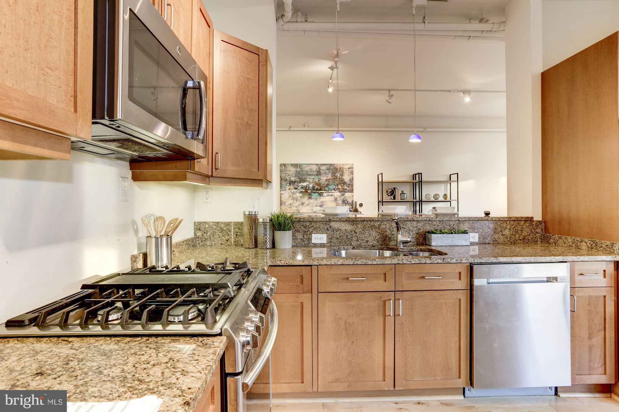 1700 Kalorama Road Northwest, Unit 312 Washington, DC 20009 - Photo 16 of 45 a kitchen with stainless steel appliances granite countertop a stove a sink and a microwave