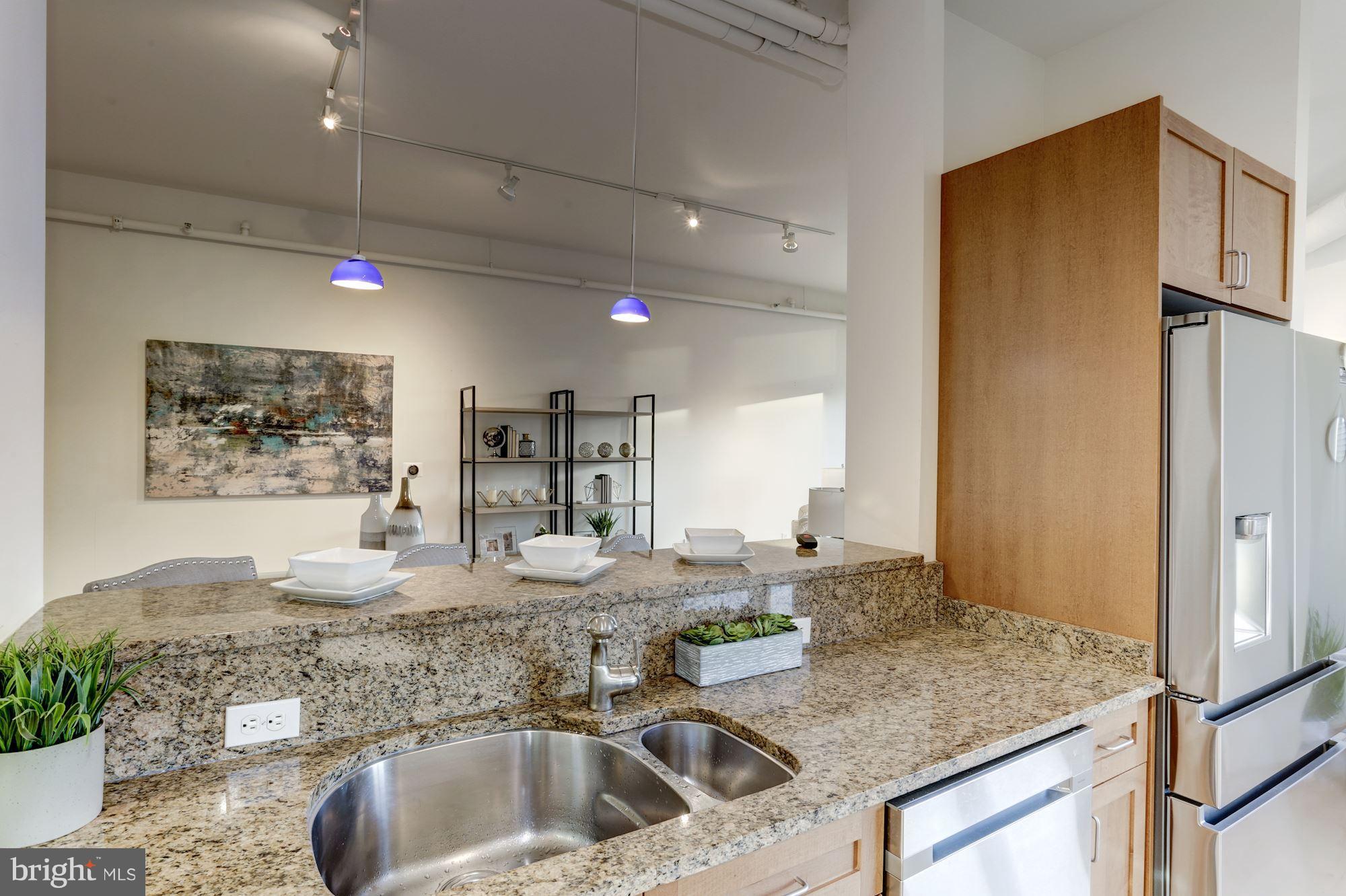 1700 Kalorama Road Northwest, Unit 312 Washington, DC 20009 - Photo 17 of 45 a kitchen with kitchen island a sink stove and refrigerator