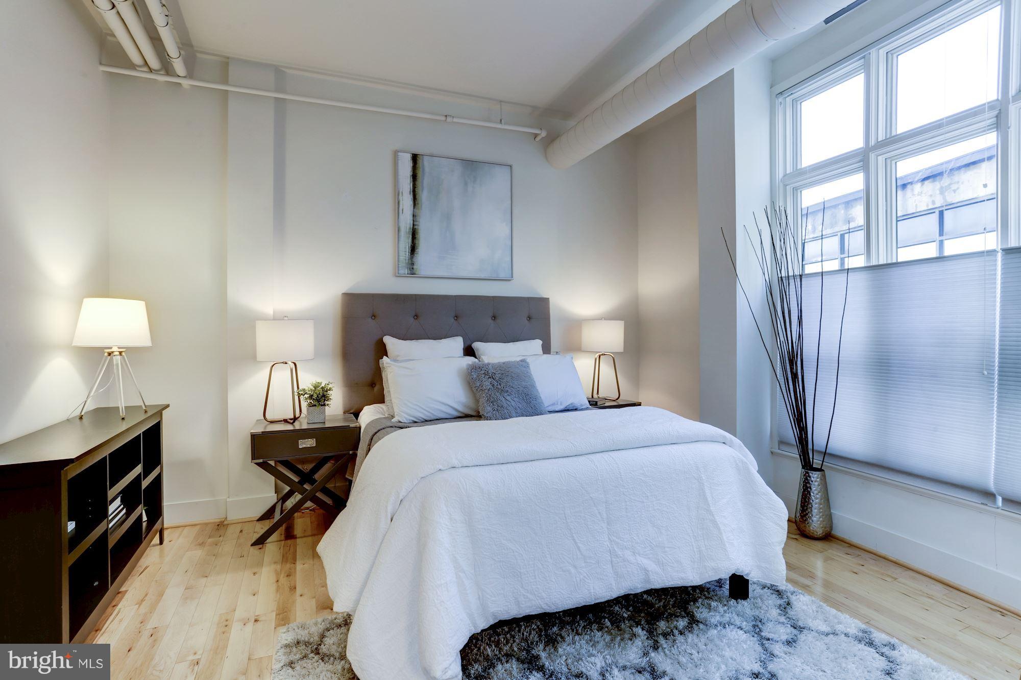 1700 Kalorama Road Northwest, Unit 312 Washington, DC 20009 - Photo 18 of 45 a bedroom with a bed table closet and a window