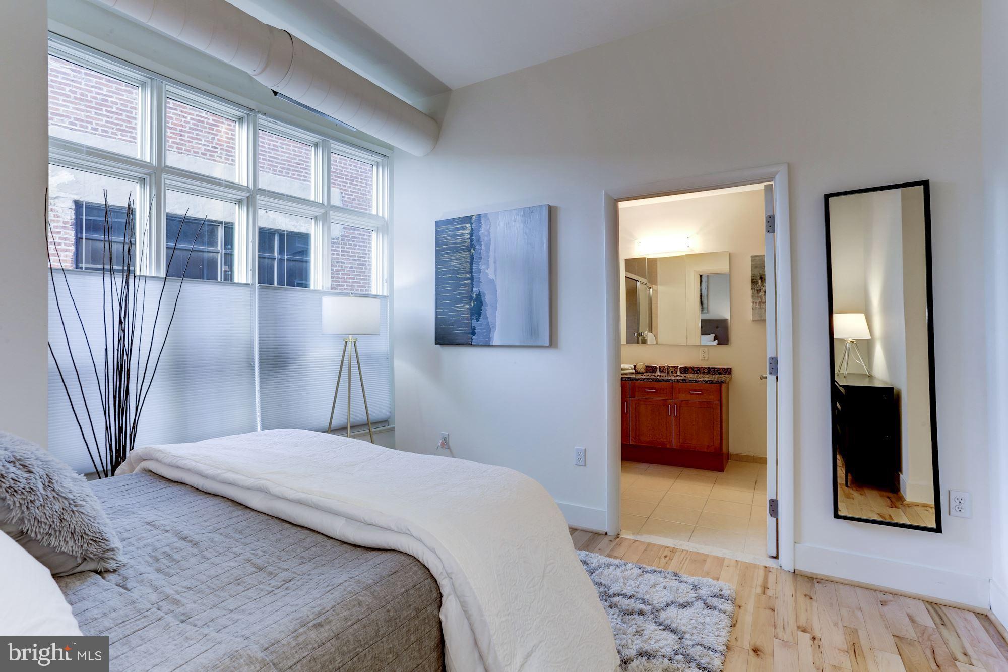 1700 Kalorama Road Northwest, Unit 312 Washington, DC 20009 - Photo 21 of 45 a bedroom with a bed and a large mirror in it