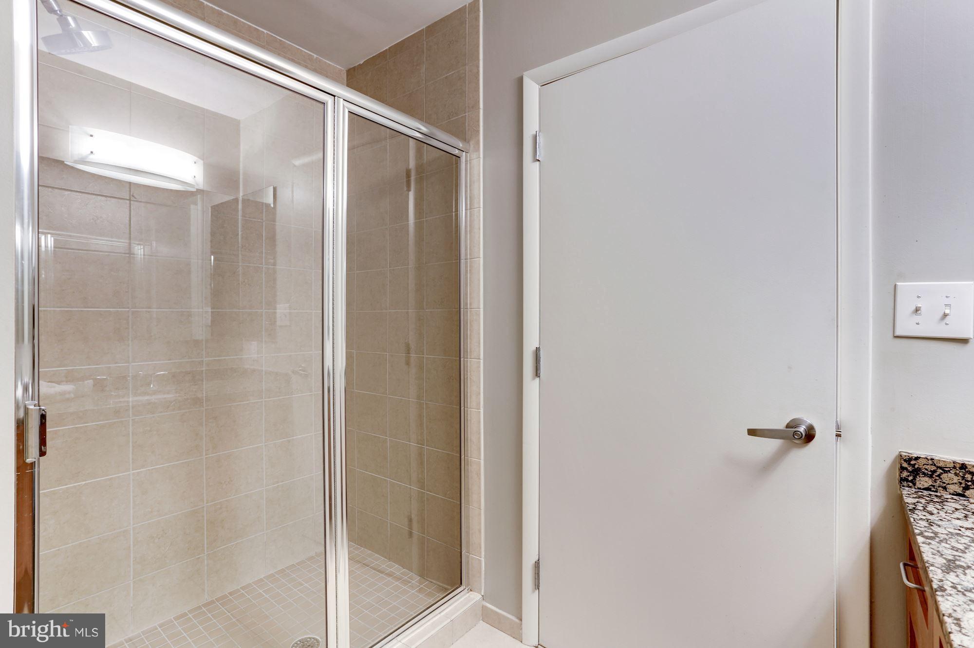 1700 Kalorama Road Northwest, Unit 312 Washington, DC 20009 - Photo 25 of 45 a bathroom with a glass shower door