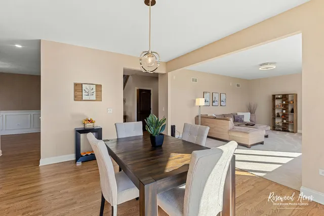 a view of a dining room with furniture wooden floor and chandelier