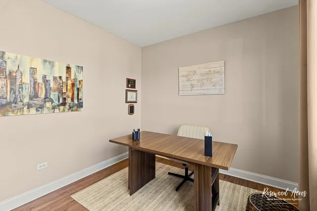 a view of a workspace with furniture and a window