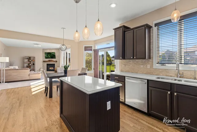a kitchen with a sink a counter space and wooden floor