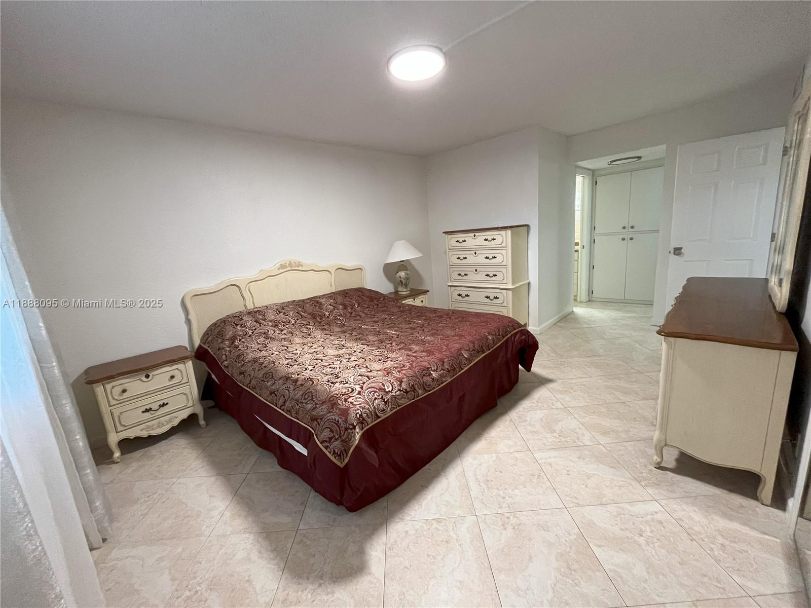 3090 North Course Drive, Unit 304 Pompano Beach, FL 33069 - Photo 11 of 16 a bedroom with a bed and window