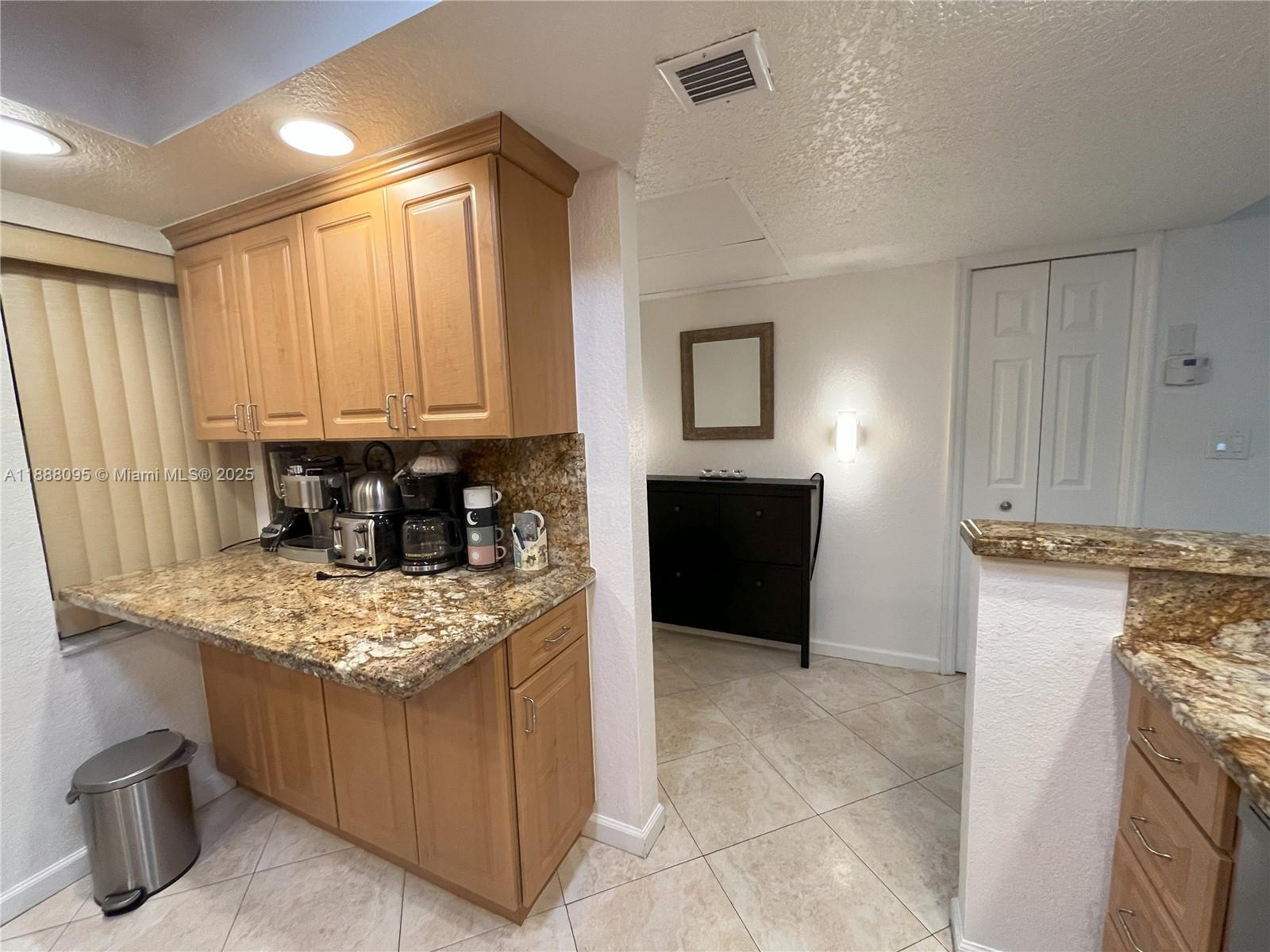 3090 North Course Drive, Unit 304 Pompano Beach, FL 33069 - Photo 5 of 16 a kitchen with a stove and a refrigerator