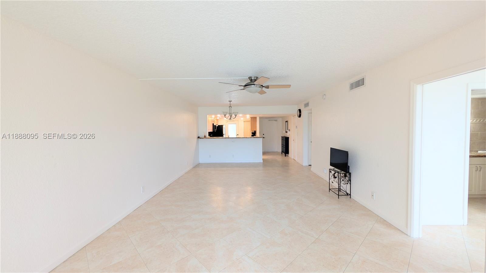 3090 North Course Drive, Unit 304 Pompano Beach, FL 33069 - Photo 6 of 13 a view of a livingroom and a kitchen
