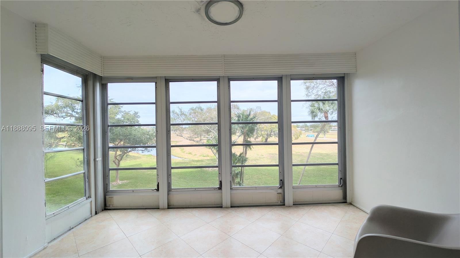 3090 North Course Drive, Unit 304 Pompano Beach, FL 33069 - Photo 7 of 13 a view of a livingroom with furniture and a window