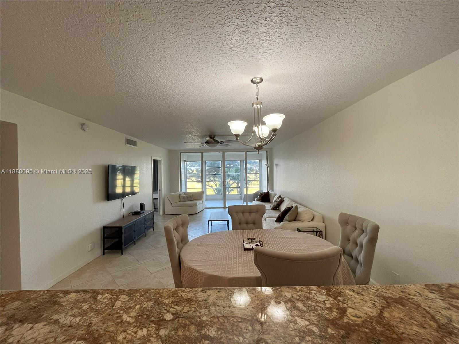 3090 North Course Drive, Unit 304 Pompano Beach, FL 33069 - Photo 7 of 16 a view of a living room and dining room