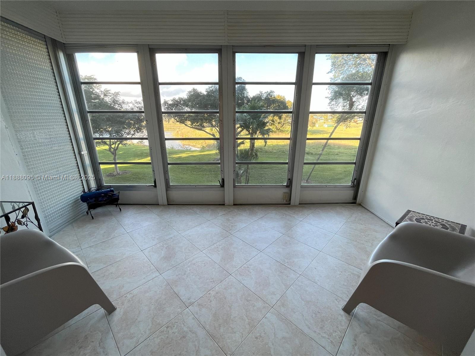 3090 North Course Drive, Unit 304 Pompano Beach, FL 33069 - Photo 10 of 16 a view of a livingroom with furniture and staircase