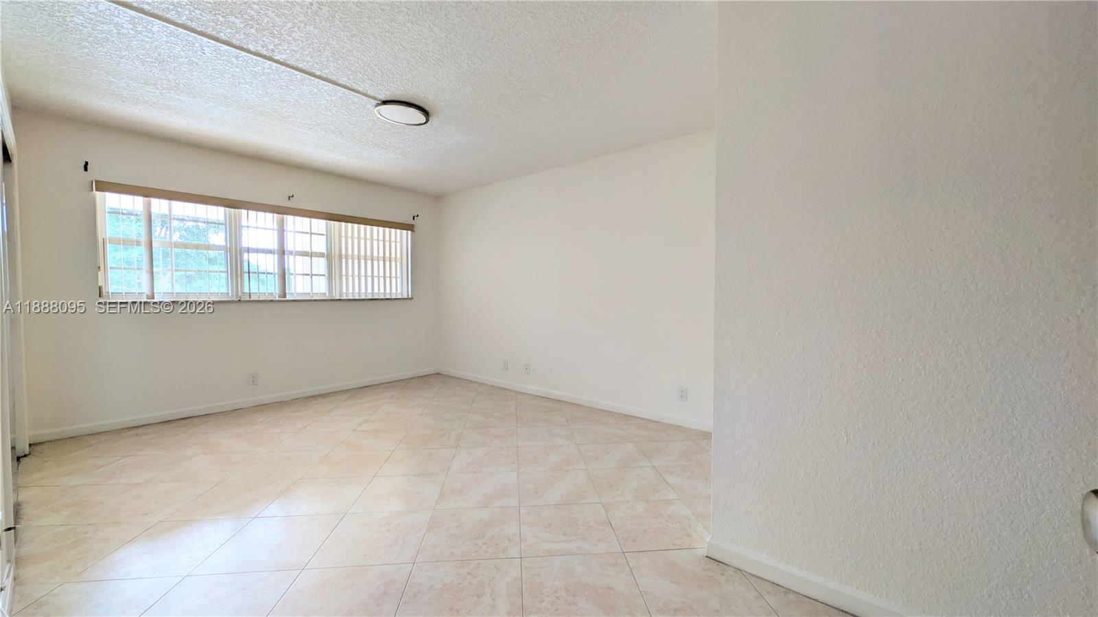 3090 North Course Drive, Unit 304 Pompano Beach, FL 33069 - Photo 10 of 13 an empty room with windows