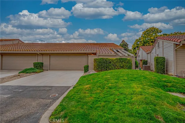 a view of a hallway with wooden floor and chandelier