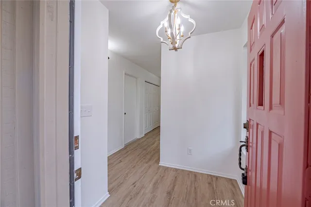 a kitchen with a wooden floor and white appliances