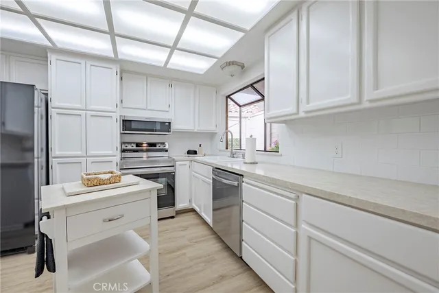 a kitchen with a sink stove and cabinets