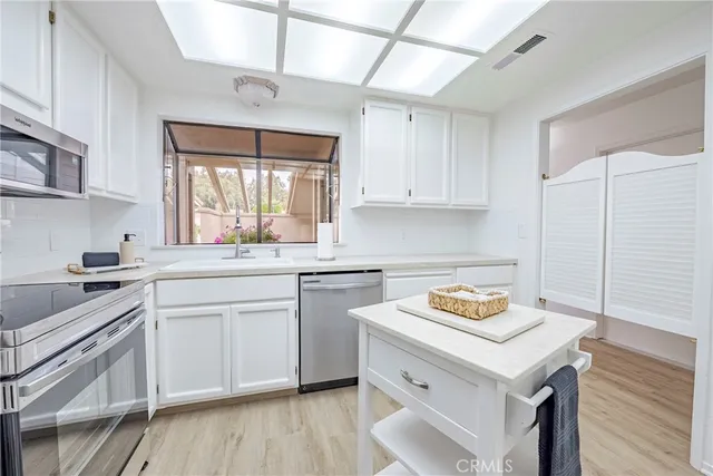 a kitchen with a sink stove and cabinets
