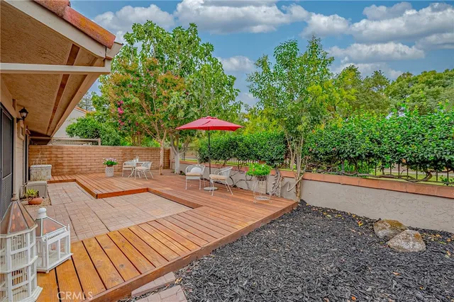 a view of a swimming pool with a patio and a yard
