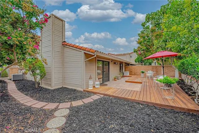 an aerial view of a house with a garden and parking