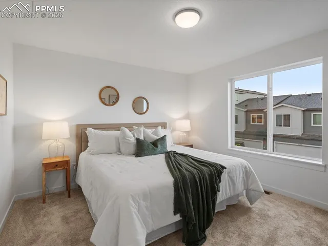 a bedroom with a large bed and a window