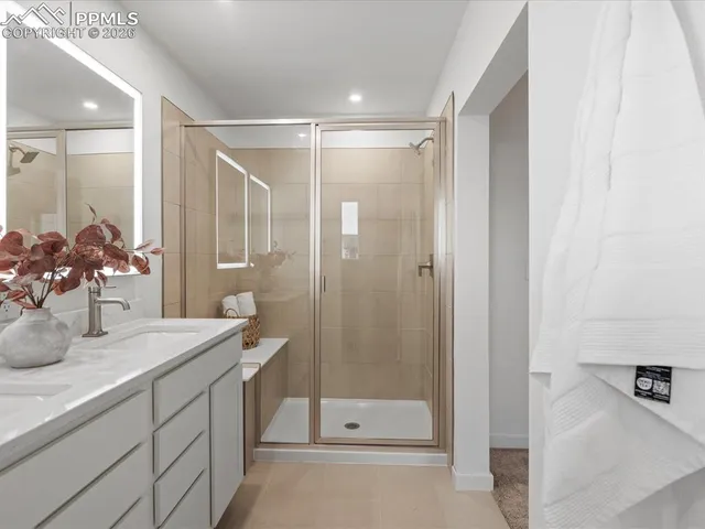 a bathroom with a double vanity sink and mirror with shower