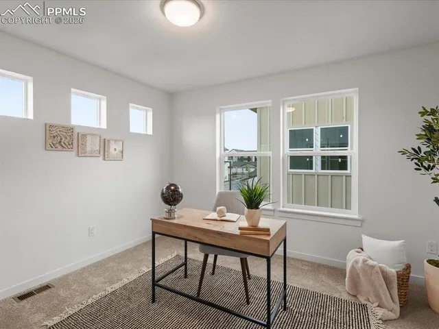 a workspace room with furniture and windows