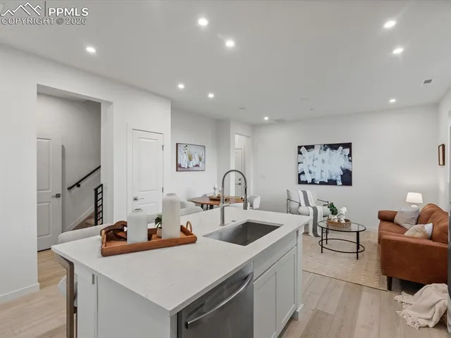 a kitchen with stainless steel appliances a sink a stove and a refrigerator
